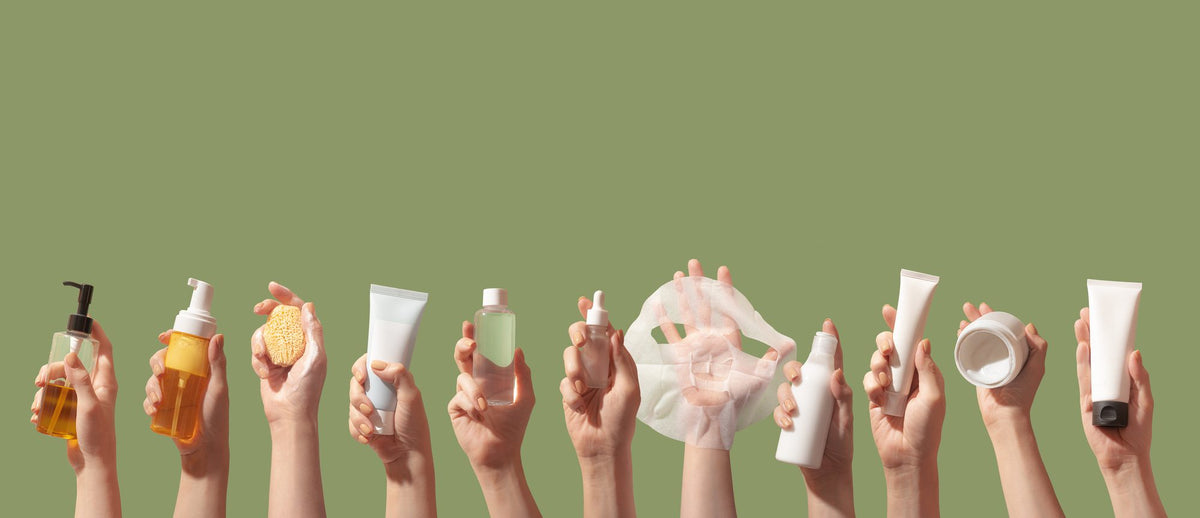 Hands holding K-beauty skincare products, one for each step of the Korean routine