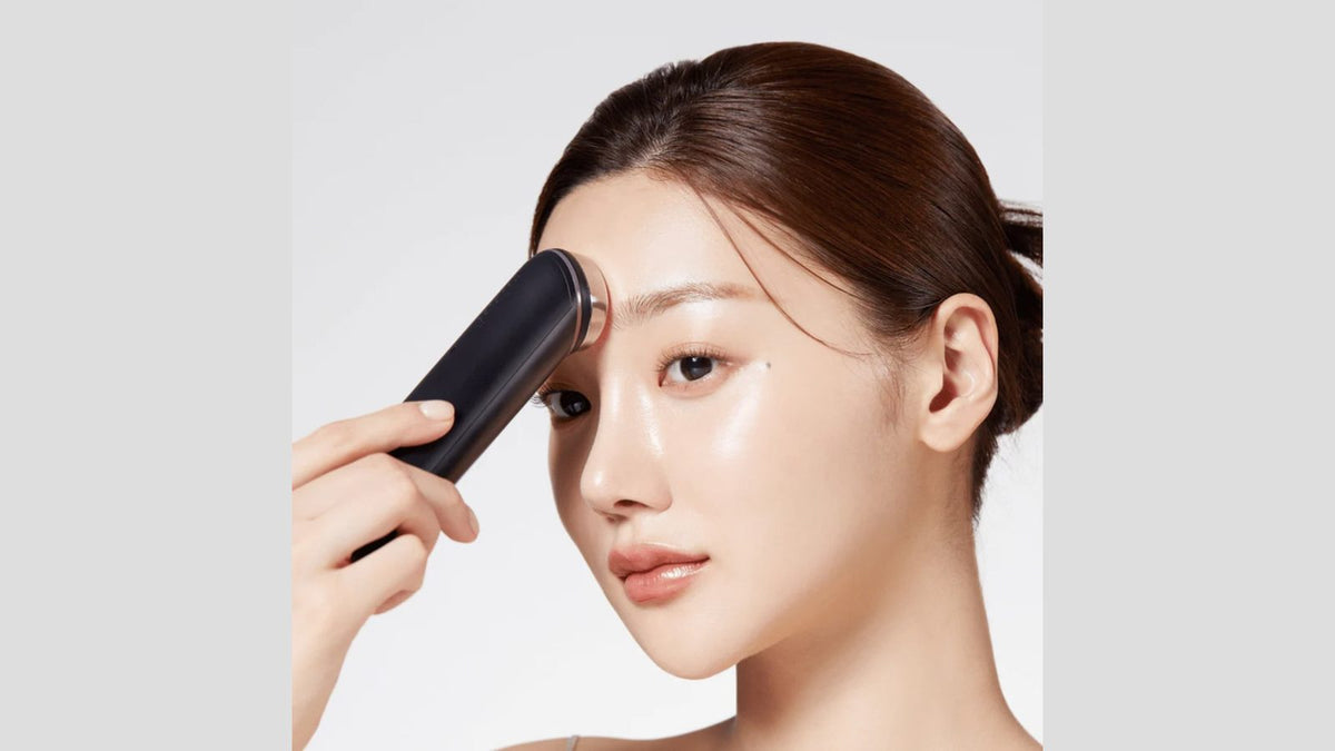 A model using the Medicube AGE-R Booster Pro device along her brow
